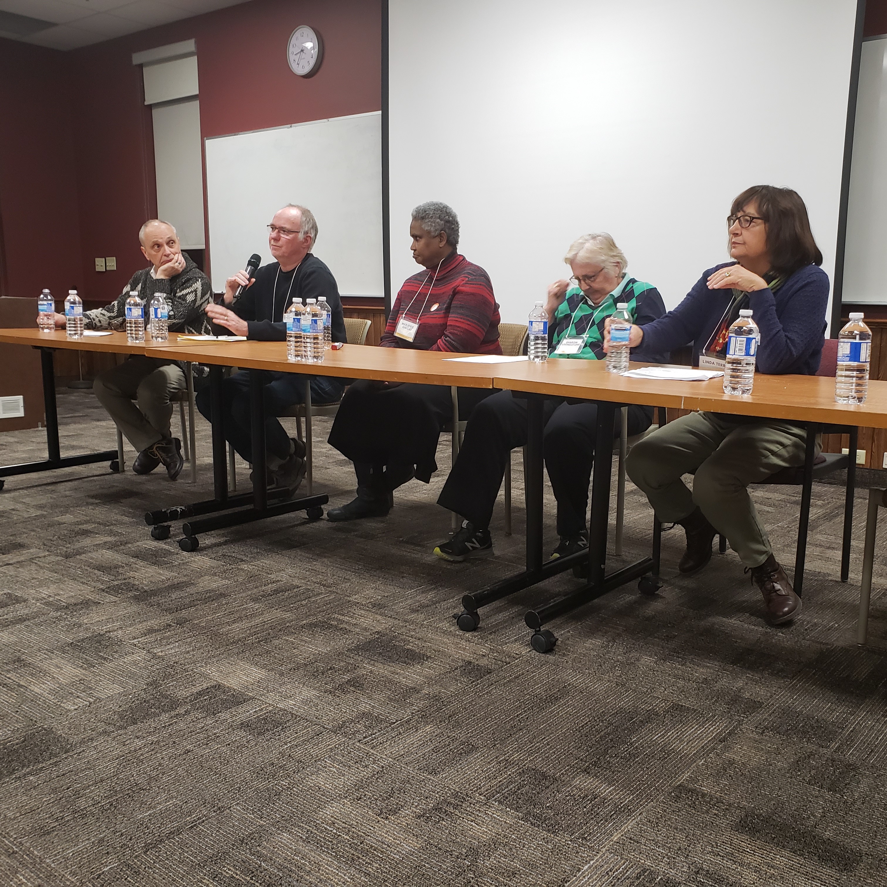 panel of speakers at poverty symposium